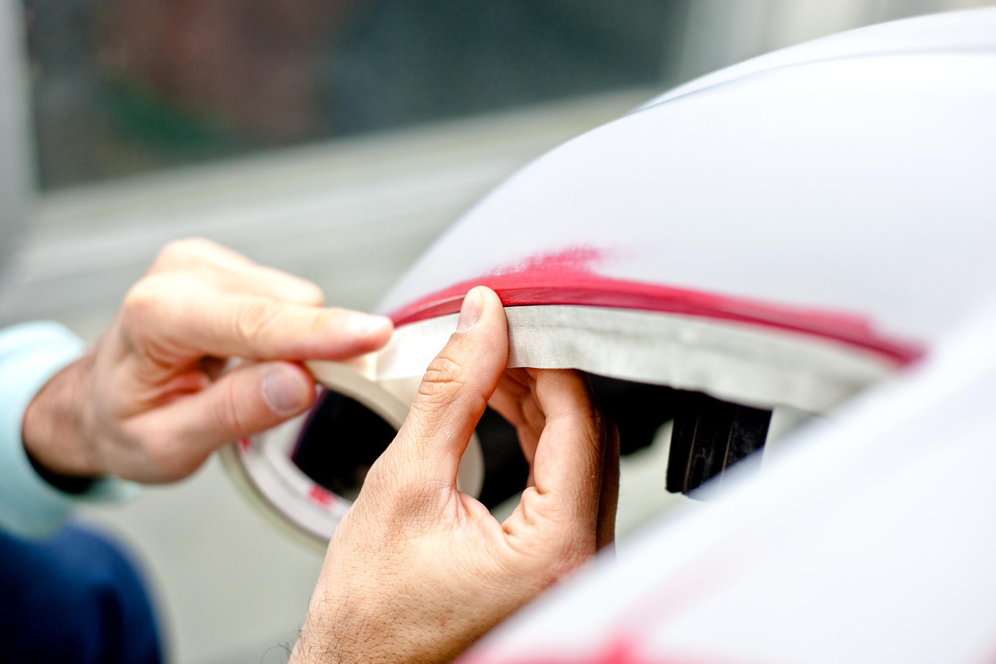 mechanic-preparing-a-car-for-painting-by-protectin-PRA39MB